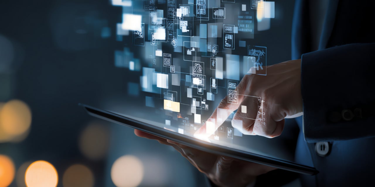 person using a tablet with glowing digital icons and data blocks, symbolizing technology and innovation