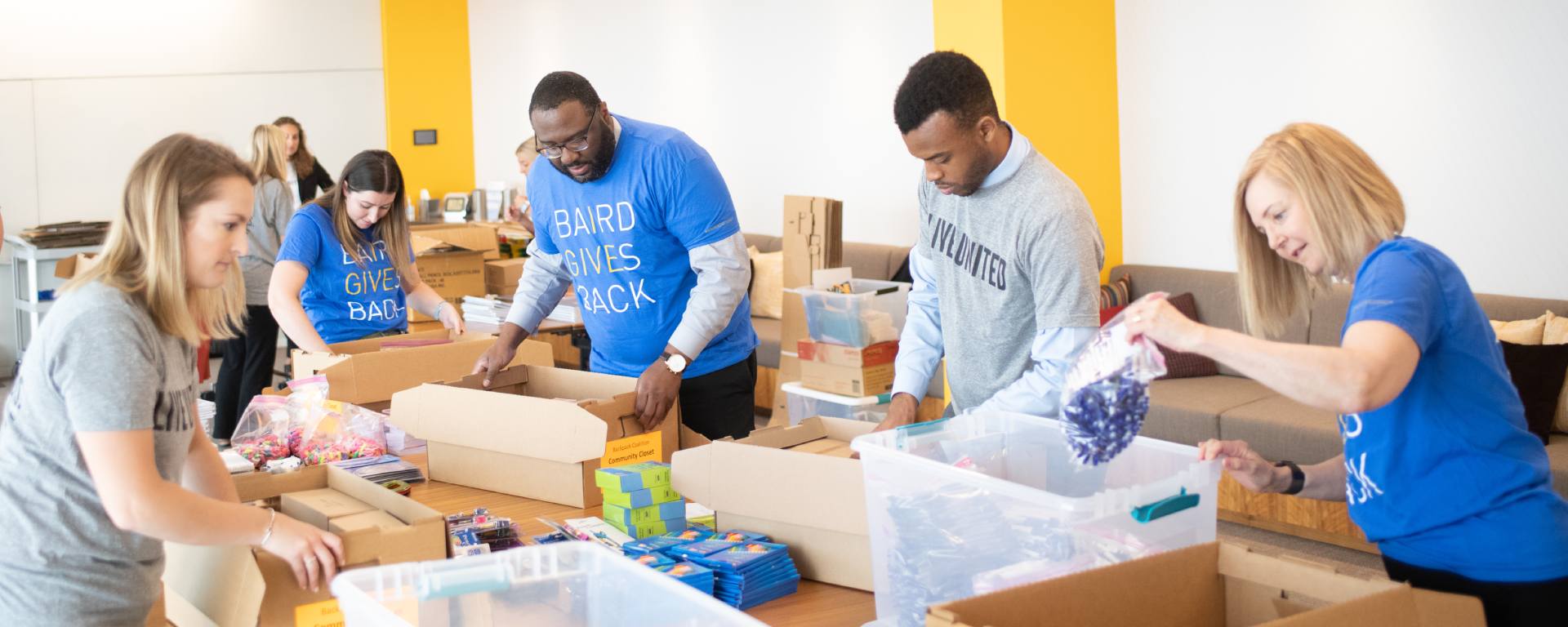Group of Nexus Associates packing food boxes.