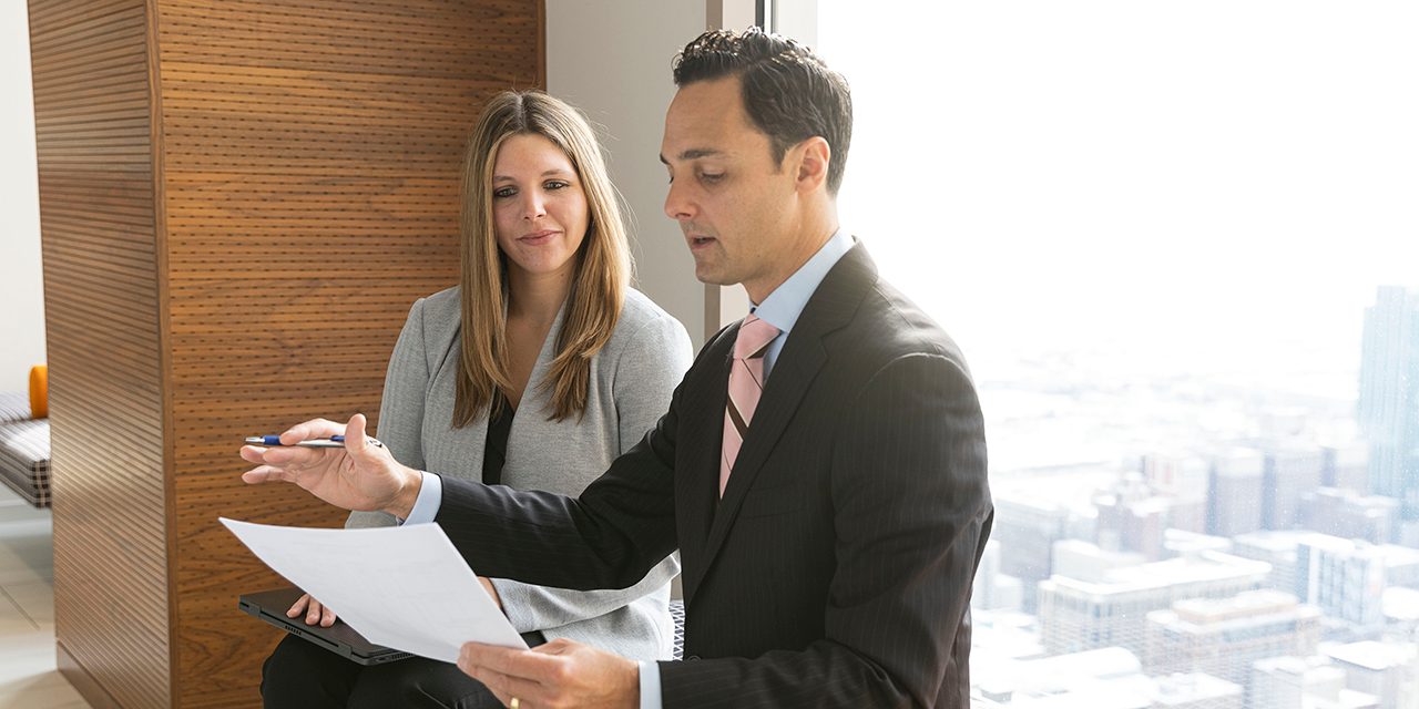  Nexus Fixed Income Capital Markets associates talking in front of a window in Chicago