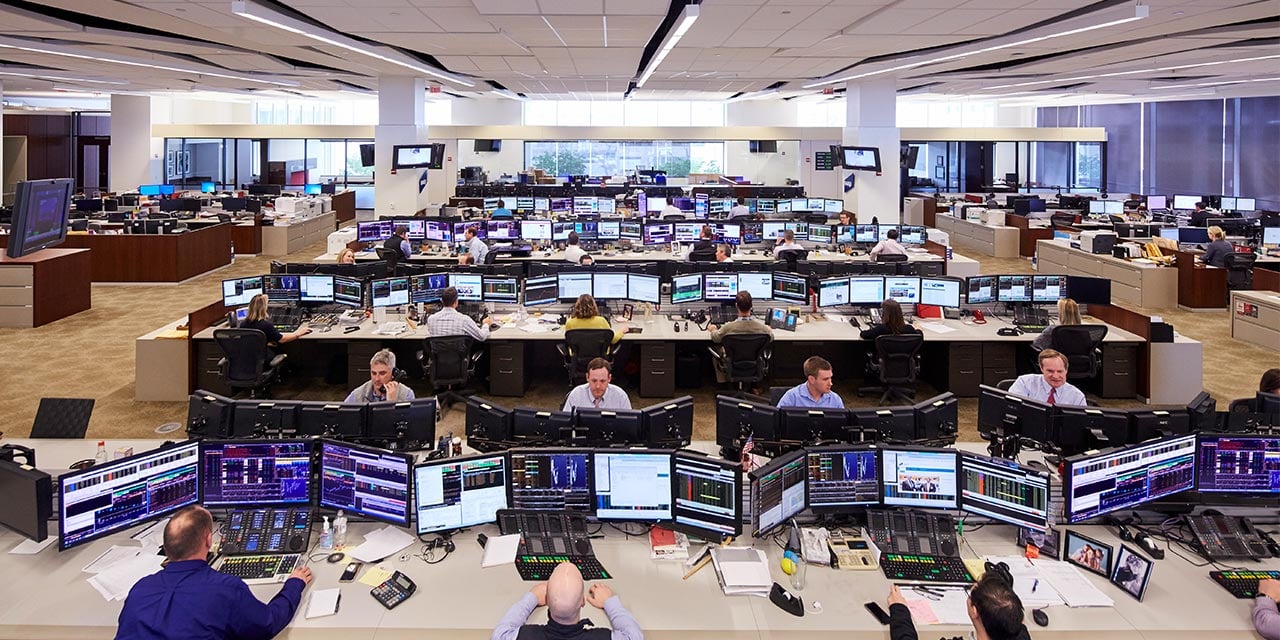  Nexus trading floor wide angle shot of traders at desks looking at computers.