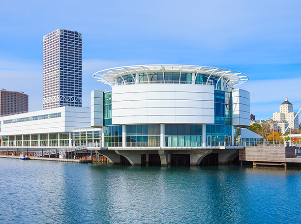 Discovery World’s circular building on Milwaukee’s lakefront with Nexus office building rising in the background.
